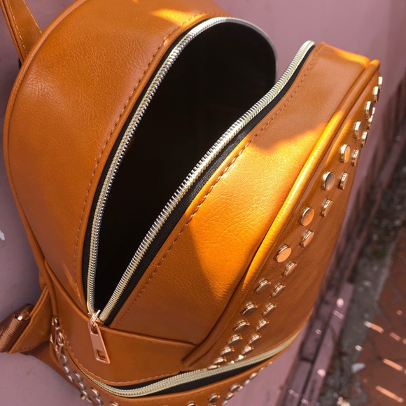 Selling a tan purse with studs surround the purse. - Picture 4 of 4